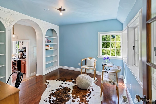 5940 Rose Loop NE, Bainbridge Island, WA 98110 - sitting room with hardwood / wood-style floors, built in shelves, vaulted ceiling, and arched walkways