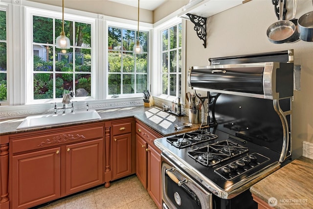 5940 Rose Loop NE, Bainbridge Island, WA 98110 - kitchen featuring healthy amount of natural light, pendant lighting, stainless steel range with gas stovetop, and dark countertops
