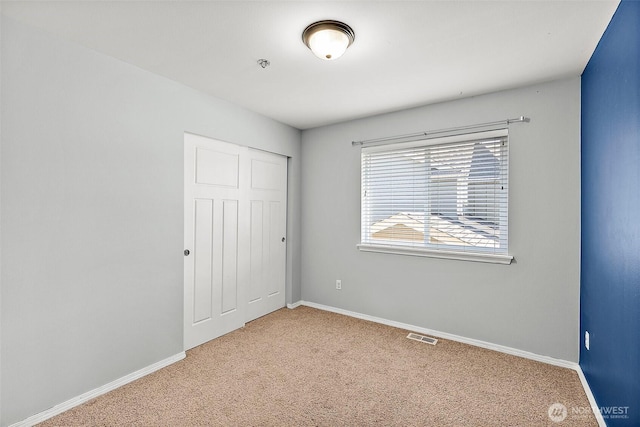 1208 Goldfinch Ave SW, Orting, WA 98360 - unfurnished bedroom featuring carpet flooring and a closet
