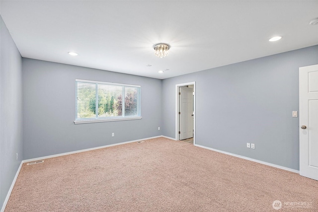1208 Goldfinch Ave SW, Orting, WA 98360 - spare room with light colored carpet, recessed lighting, and a smoke detector