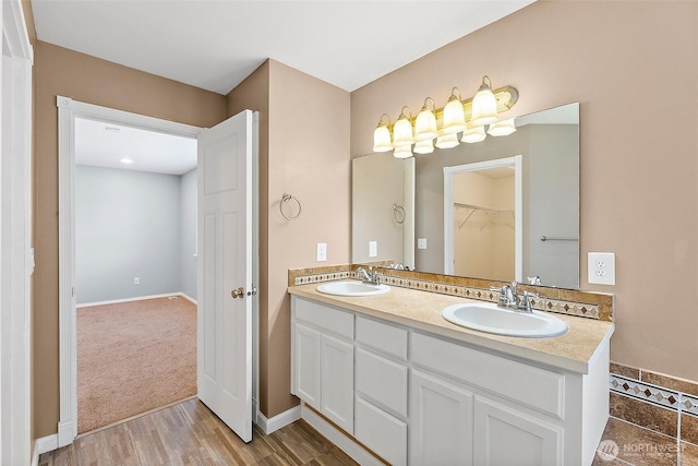 1208 Goldfinch Ave SW, Orting, WA 98360 - full bath with double vanity, wood finished floors, and a walk in closet