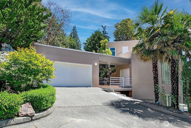 11115 NE 95th St, Kirkland, WA 98033 - modern home featuring concrete driveway, an attached garage, and stucco siding