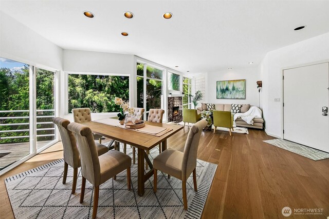 11115 NE 95th St, Kirkland, WA 98033 - dining space featuring recessed lighting, wood finished floors, and a lit fireplace