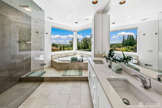 11115 NE 95th St, Kirkland, WA 98033 - bathroom with a bath, double vanity, healthy amount of natural light, a tile shower, and recessed lighting