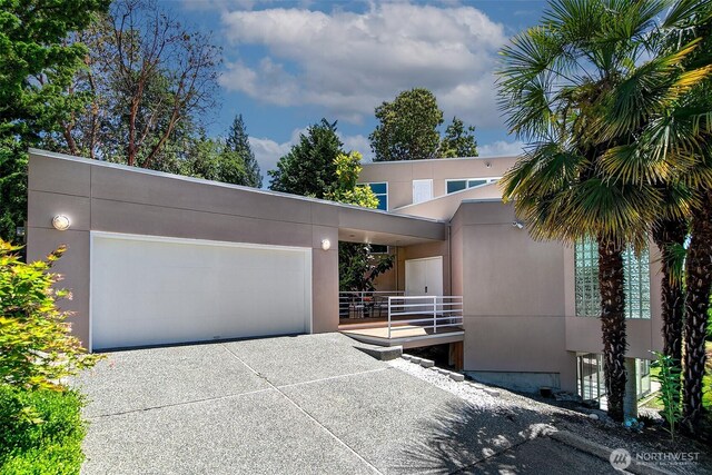11115 NE 95th St, Kirkland, WA 98033 - contemporary house with an attached garage, concrete driveway, and stucco siding