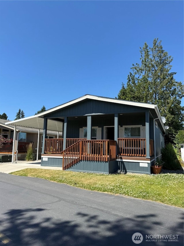 2101 S 324th St Unit 107, Federal Way, WA 98003 - manufactured / mobile home featuring a porch and a carport