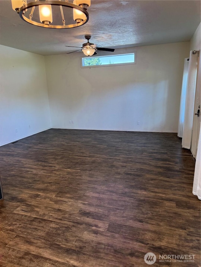2101 S 324th St Unit 107, Federal Way, WA 98003 - spare room featuring a chandelier and dark wood-type flooring