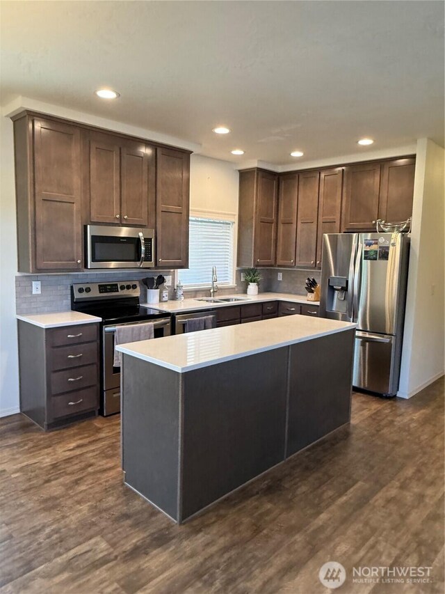 2101 S 324th St Unit 107, Federal Way, WA 98003 - kitchen with stainless steel appliances, a sink, decorative backsplash, recessed lighting, and light countertops