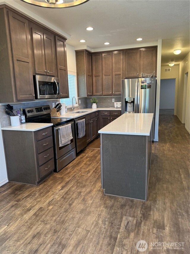 2101 S 324th St Unit 107, Federal Way, WA 98003 - kitchen with appliances with stainless steel finishes, a sink, dark brown cabinets, dark wood finished floors, and recessed lighting
