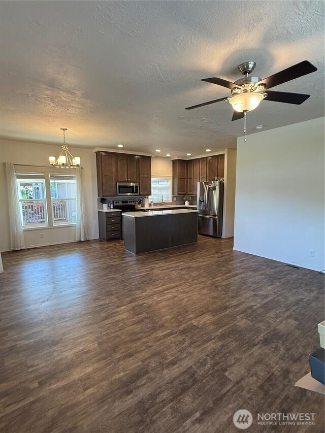 2101 S 324th St Unit 107, Federal Way, WA 98003 - kitchen with appliances with stainless steel finishes, open floor plan, a chandelier, dark wood-type flooring, and healthy amount of natural light