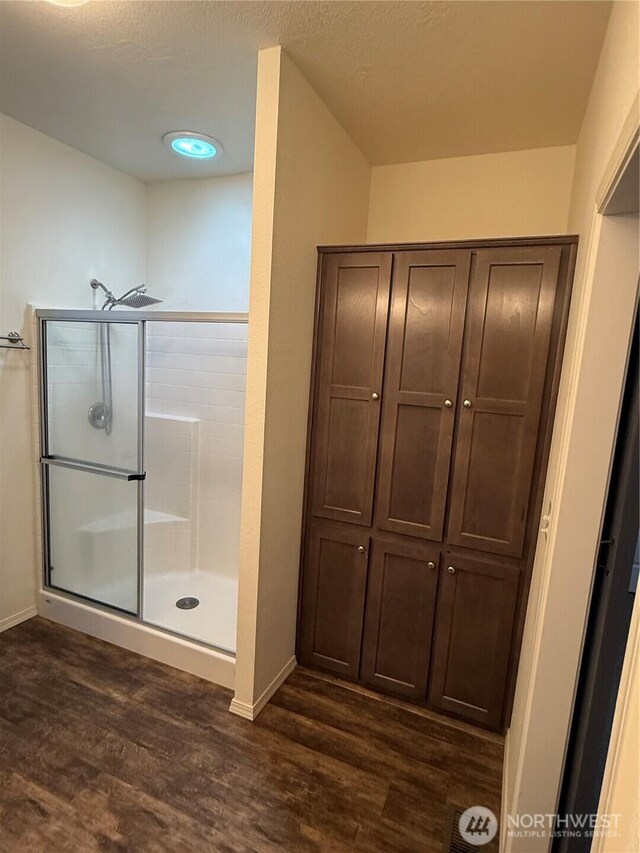 2101 S 324th St Unit 107, Federal Way, WA 98003 - full bath with wood finished floors, a shower stall, and baseboards