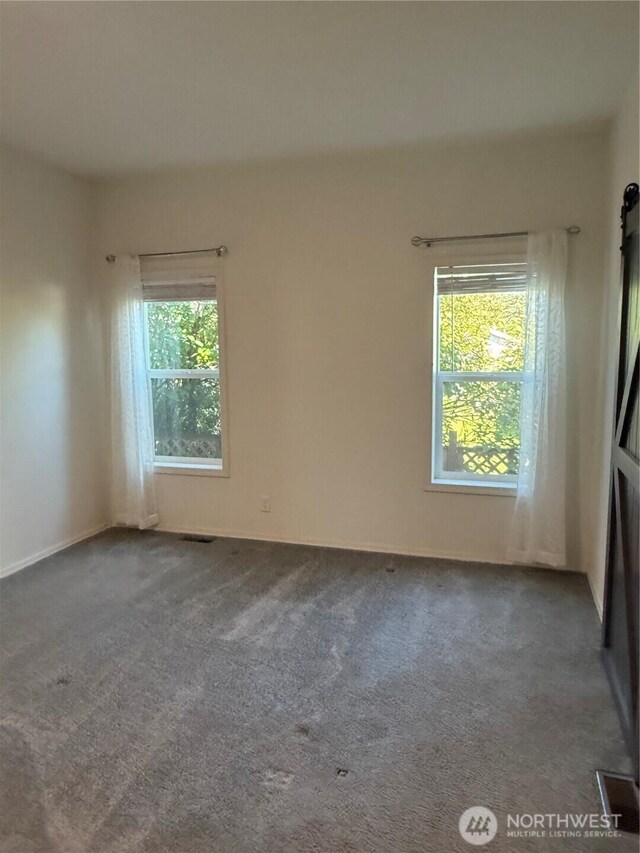 2101 S 324th St Unit 107, Federal Way, WA 98003 - spare room featuring plenty of natural light and carpet flooring