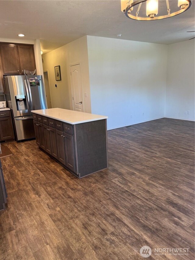 2101 S 324th St Unit 107, Federal Way, WA 98003 - kitchen with stainless steel fridge, dark wood finished floors, light countertops, and dark brown cabinets