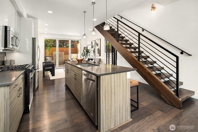 252 E Roanoke St, Seattle, WA 98102 - kitchen with stainless steel appliances, modern cabinets, dark countertops, dark wood finished floors, and recessed lighting