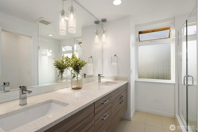 252 E Roanoke St, Seattle, WA 98102 - full bath with double vanity, tile patterned flooring, a shower stall, and tasteful backsplash