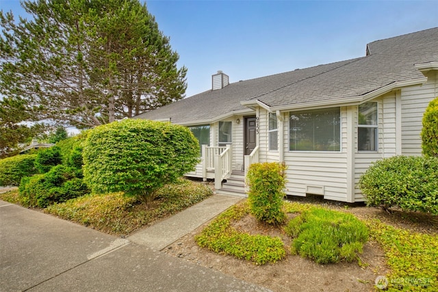 9757 Spinnaker Blvd NW, Silverdale, WA 98383 - view of front of home with a chimney and a shingled roof