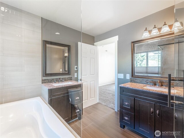 2422 Highland View Dr, East Wenatchee, WA 98802 - bathroom with a bath, two vanities, and wood finished floors