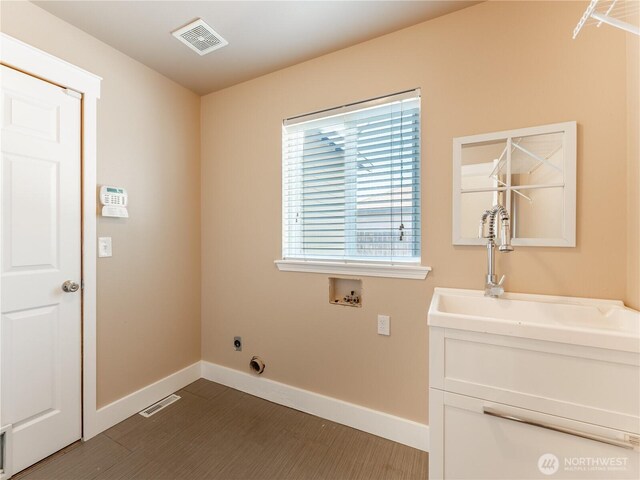 2422 Highland View Dr, East Wenatchee, WA 98802 - laundry room with baseboards, hookup for a washing machine, and cabinet space