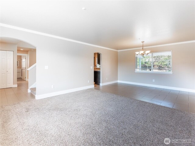 2422 Highland View Dr, East Wenatchee, WA 98802 - unfurnished room featuring tile patterned floors, arched walkways, carpet floors, and crown molding