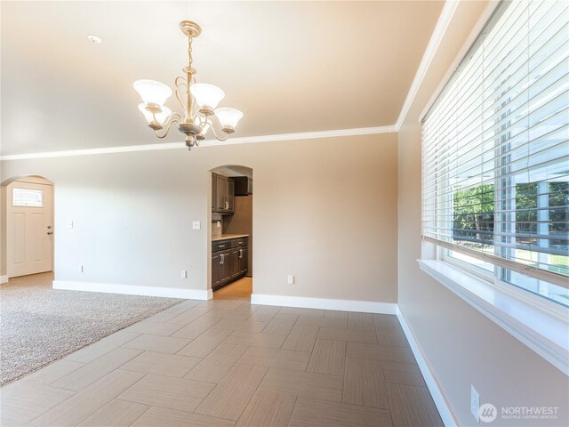 2422 Highland View Dr, East Wenatchee, WA 98802 - spare room with arched walkways, baseboards, a chandelier, and ornamental molding