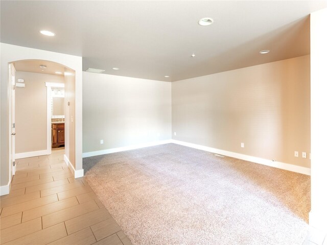 2422 Highland View Dr, East Wenatchee, WA 98802 - spare room featuring arched walkways, recessed lighting, baseboards, and light colored carpet