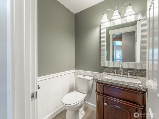 2422 Highland View Dr, East Wenatchee, WA 98802 - half bathroom featuring toilet, wainscoting, and vanity