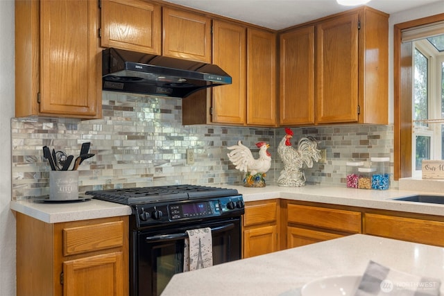 3905 109th Pl SE, Everett, WA 98208 - kitchen with black gas range, range hood, light countertops, and backsplash