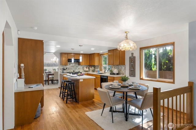 3905 109th Pl SE, Everett, WA 98208 - dining area featuring light wood-style flooring, plenty of natural light, and a chandelier