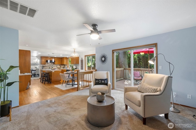 3905 109th Pl SE, Everett, WA 98208 - living room featuring a ceiling fan, light carpet, and light wood-style flooring