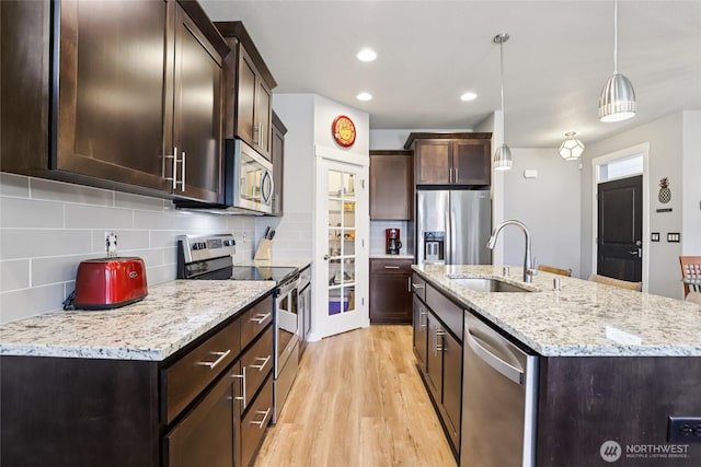 15323 NE 108th Way, Vancouver, WA 98682 - kitchen with appliances with stainless steel finishes, light wood-type flooring, backsplash, an island with sink, and recessed lighting