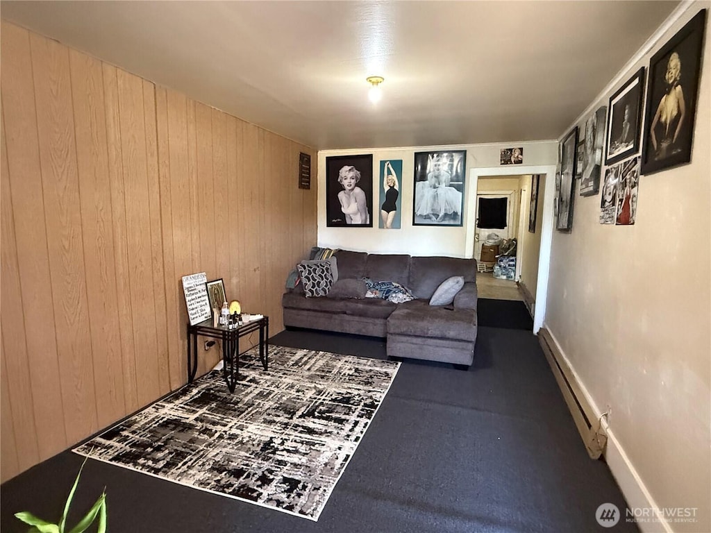 400 9th St, Raymond, WA 98577 - living area featuring a baseboard heating unit and wooden walls