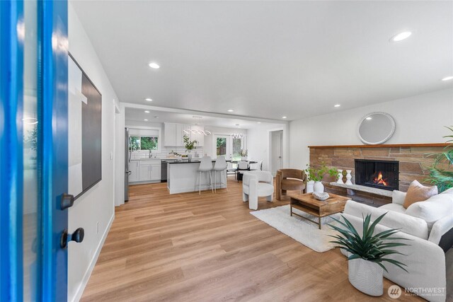 7713 NE 141st St, Kirkland, WA 98034 - living area featuring recessed lighting, light wood-style flooring, and a stone fireplace