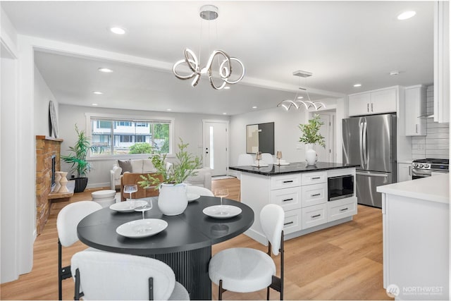7713 NE 141st St, Kirkland, WA 98034 - dining area featuring light wood-style flooring, recessed lighting, and a chandelier