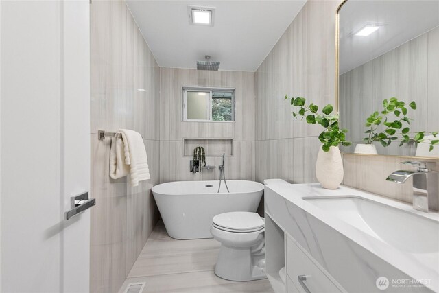 7713 NE 141st St, Kirkland, WA 98034 - bathroom with a soaking tub, vanity, tile walls, and wood finished floors