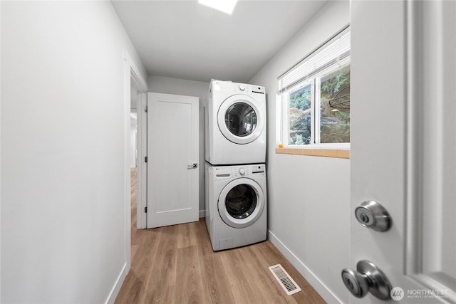 7713 NE 141st St, Kirkland, WA 98034 - washroom with stacked washer / dryer and light wood-style floors
