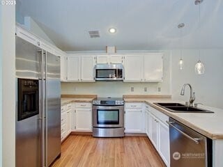 2518 NE 82nd Way, Vancouver, WA 98665 - kitchen featuring appliances with stainless steel finishes, a sink, a peninsula, light countertops, and white cabinetry