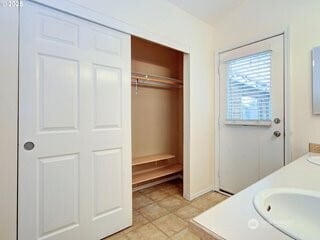 2518 NE 82nd Way, Vancouver, WA 98665 - full bathroom featuring double vanity, baseboards, a walk in closet, and tile patterned flooring