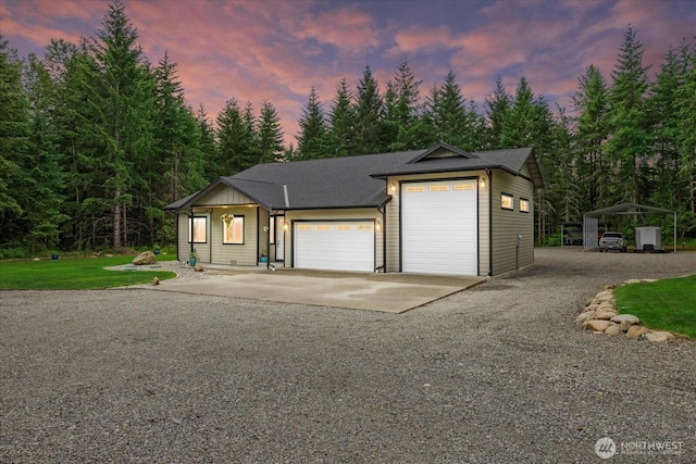 18705 232nd Ave E, Orting, WA 98360 - view of front of house featuring concrete driveway, a front lawn, and an attached garage