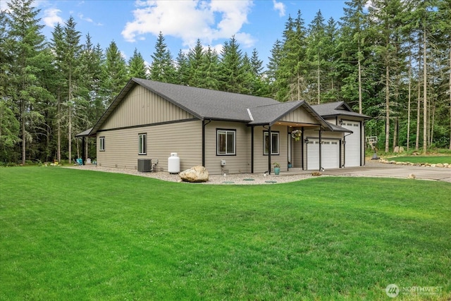 18705 232nd Ave E, Orting, WA 98360 - view of front facade featuring driveway, a garage, a front yard, and roof with shingles