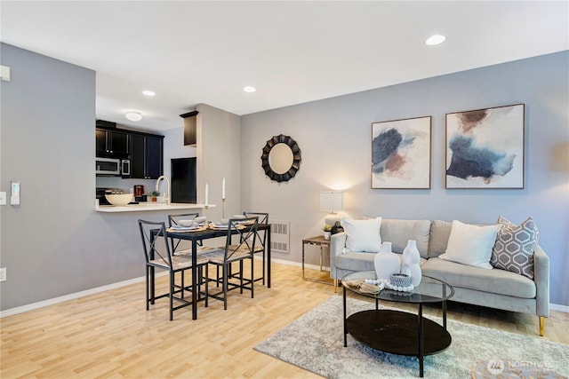 3446A 34th Ave W, Seattle, WA 98199 - living room featuring light wood-style flooring and recessed lighting