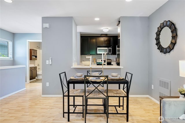 3446A 34th Ave W, Seattle, WA 98199 - dining area featuring light wood finished floors, recessed lighting, and heating unit