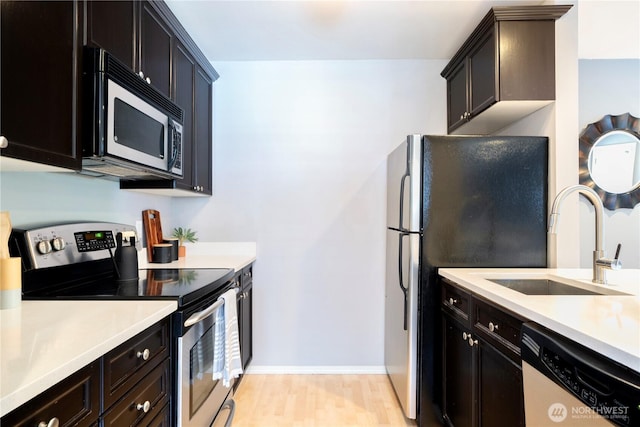 3446A 34th Ave W, Seattle, WA 98199 - kitchen with stainless steel appliances, light countertops, and light wood-style flooring