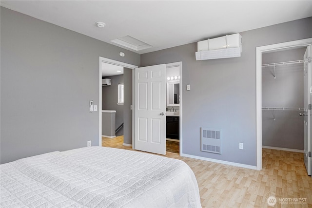 3446A 34th Ave W, Seattle, WA 98199 - bedroom with a walk in closet, light wood-style flooring, a closet, and connected bathroom
