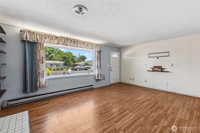 1300 Monitor Ave, Wenatchee, WA 98801 - unfurnished living room with a baseboard heating unit, wood finished floors, a textured ceiling, and baseboards