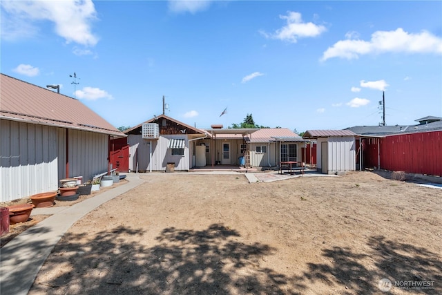 1300 Monitor Ave, Wenatchee, WA 98801 - rear view of property with board and batten siding, a patio, and metal roof