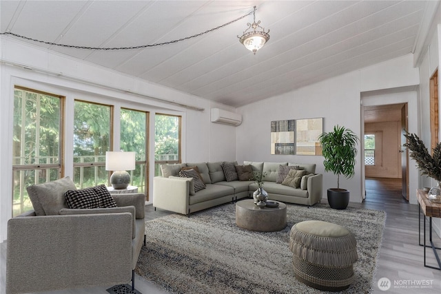 24443 Wicker Rd Unit 16, Sedro Woolley, WA 98284 - living area featuring vaulted ceiling, a wall unit AC, and wood finished floors