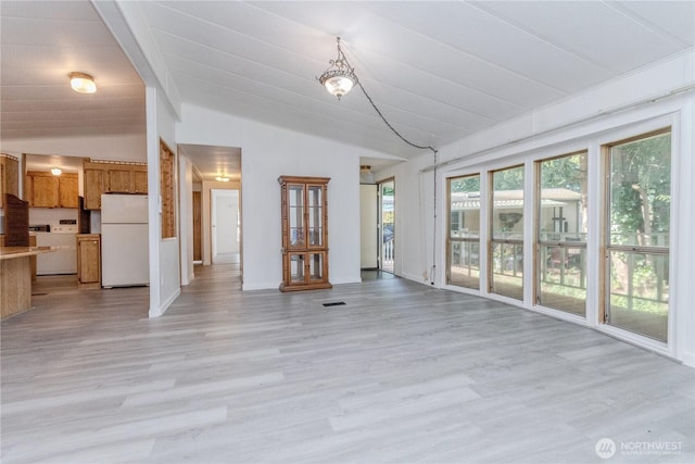24443 Wicker Rd Unit 16, Sedro Woolley, WA 98284 - unfurnished living room with vaulted ceiling and light wood finished floors