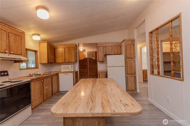 24443 Wicker Rd Unit 16, Sedro Woolley, WA 98284 - kitchen with white appliances, under cabinet range hood, brown cabinetry, lofted ceiling, and light wood-style floors
