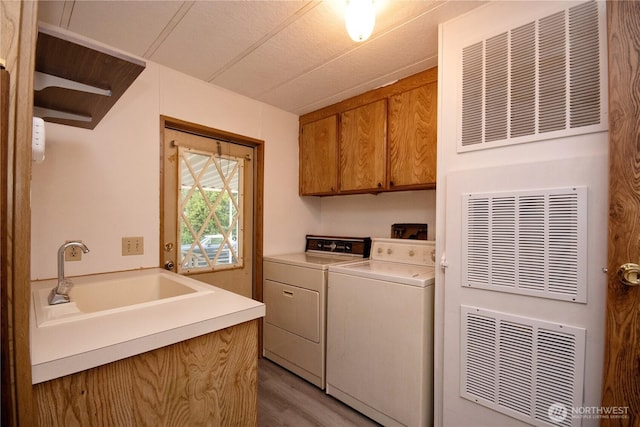 24443 Wicker Rd Unit 16, Sedro Woolley, WA 98284 - laundry room featuring cabinet space, separate washer and dryer, and light wood-type flooring