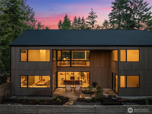580 Park Ave NE, Bainbridge Island, WA 98110 - back of house at dusk with a patio area and roof with shingles